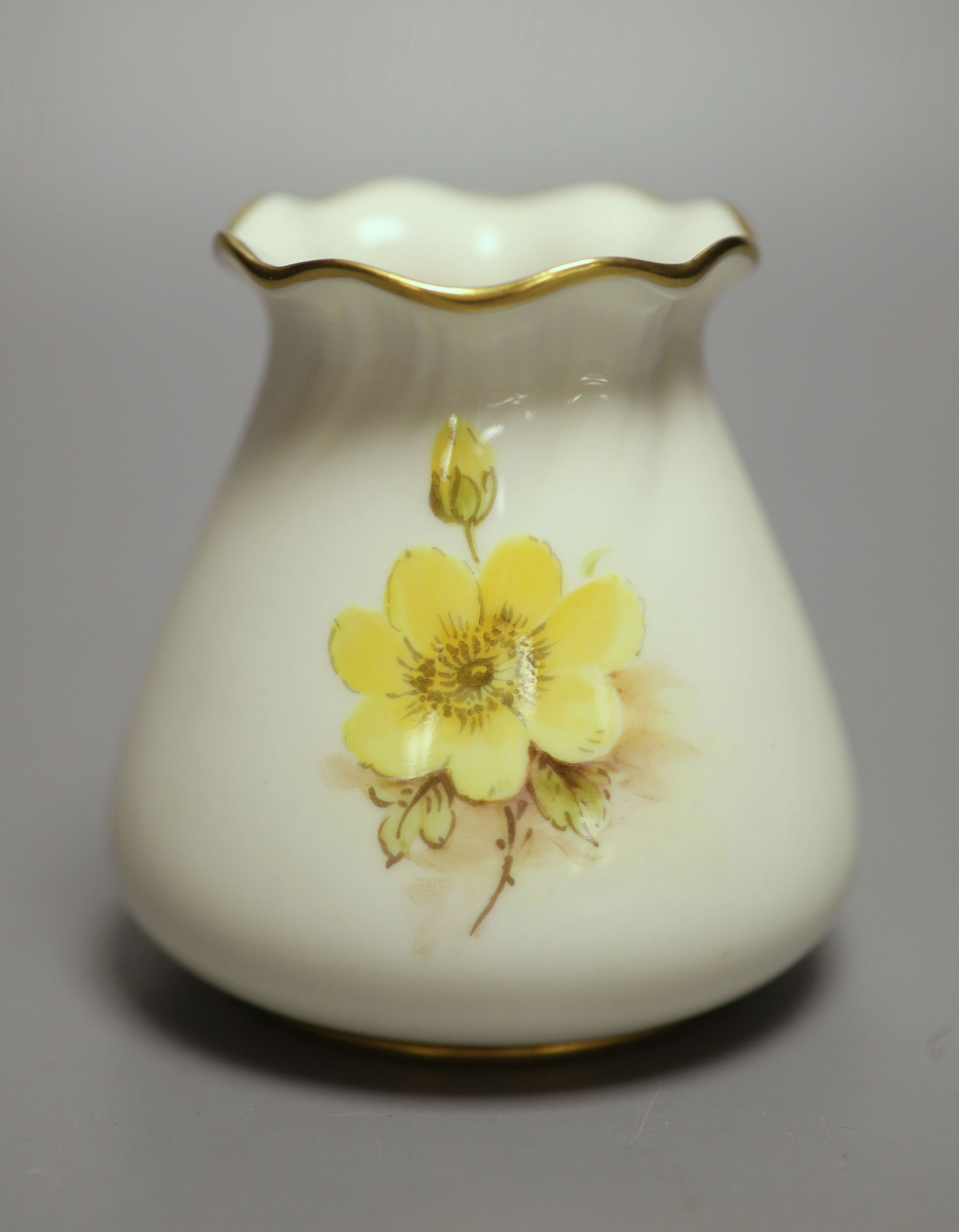 A Royal Worcester sack shape vase, with pie crust rim, painted with a fine floral study by J Freeman, signed, black date mark 1952